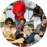 A woman in a straw hat holds a baby goat