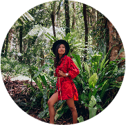 Seven women from a robotics team gathering around their robot
